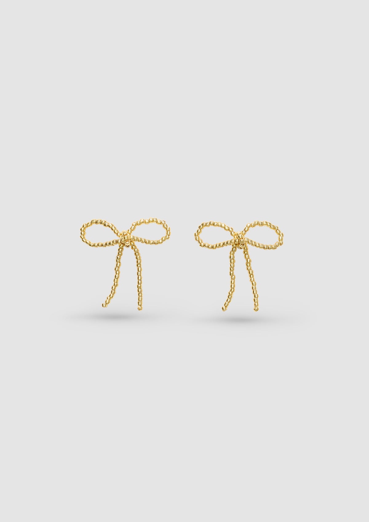 GOLD BOW EAR STICKS