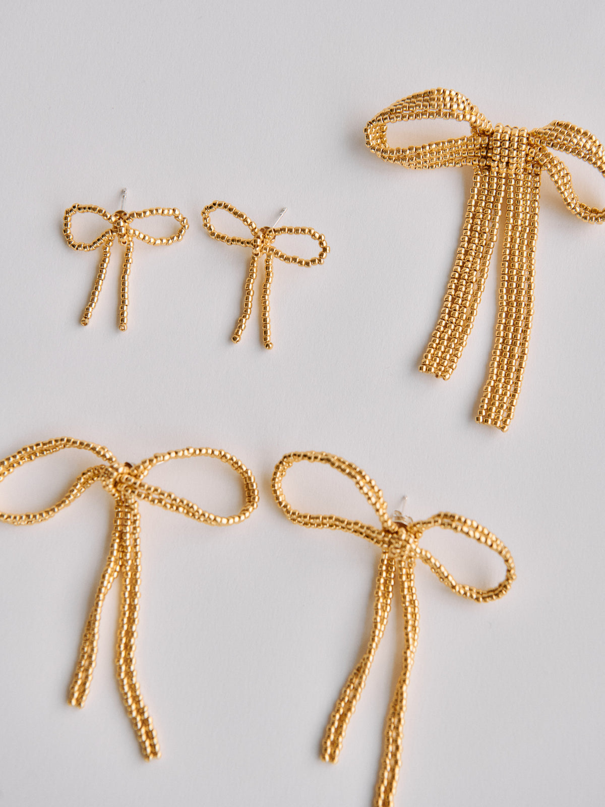 GOLD BOW EAR STICKS